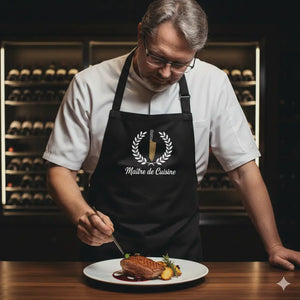 Schwarze Meatware Profi-Kochschürze mit weißem Maître de Cuisine Emblem und verstellbarem Nackenband