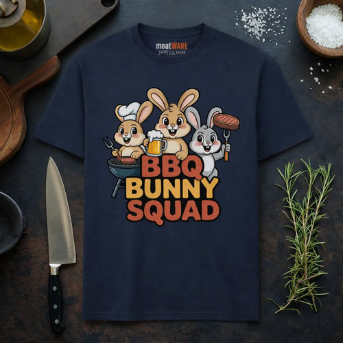 Meatware BBQ Bunny Squad Premium T-Shirt Mockup mit Grillhasen BBQ Team Design und Nackenbranding in rustikalem BBQ Küchen Setting mit Messer und Rosmarin.