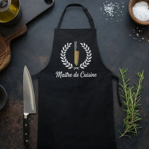Schwarze Meatware Kochschürze „Maître de Cuisine“ mit Kochmesser und Lorbeerkranz, stilvolle Küchenschürze für Kochen, Grillen und Food-Enthusiasten